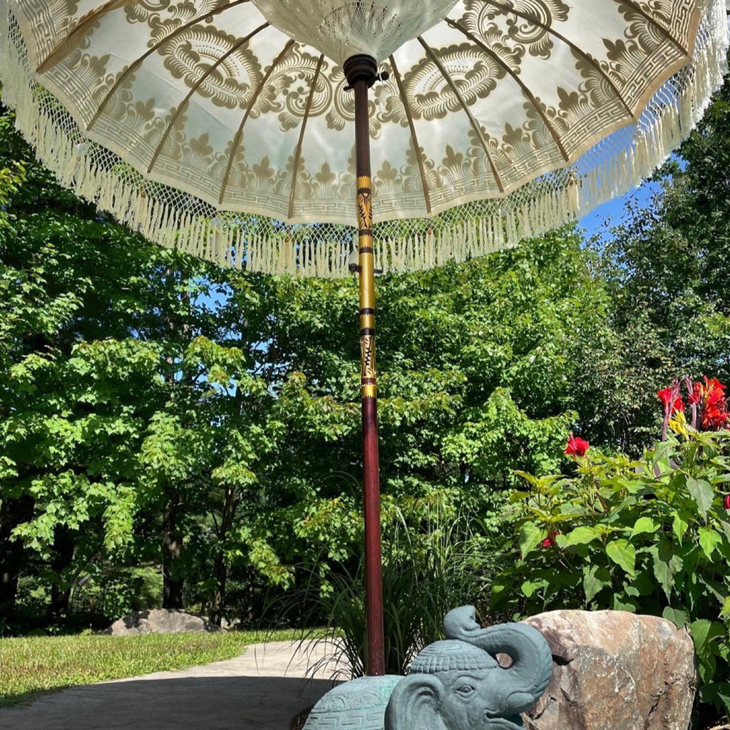 Bohemian-style Golden Abbey umbrella creating a cozy and elegant outdoor ambiance.
