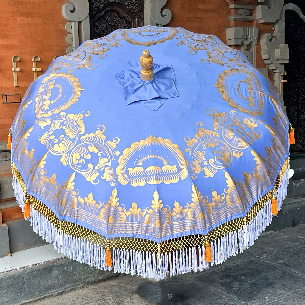 Detailed close-up of gold hand-painted lotus artwork on the Charlotte Parasol’s lavender fabric.