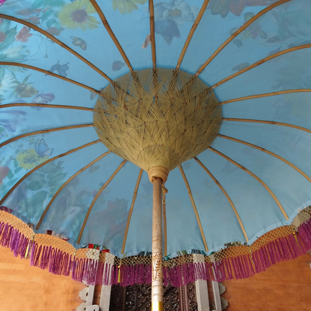 Underside of the Butterfly Parasol, showing its bamboo rib structure, intricate woven details, and the translucent effect of the floral and butterfly patterns.