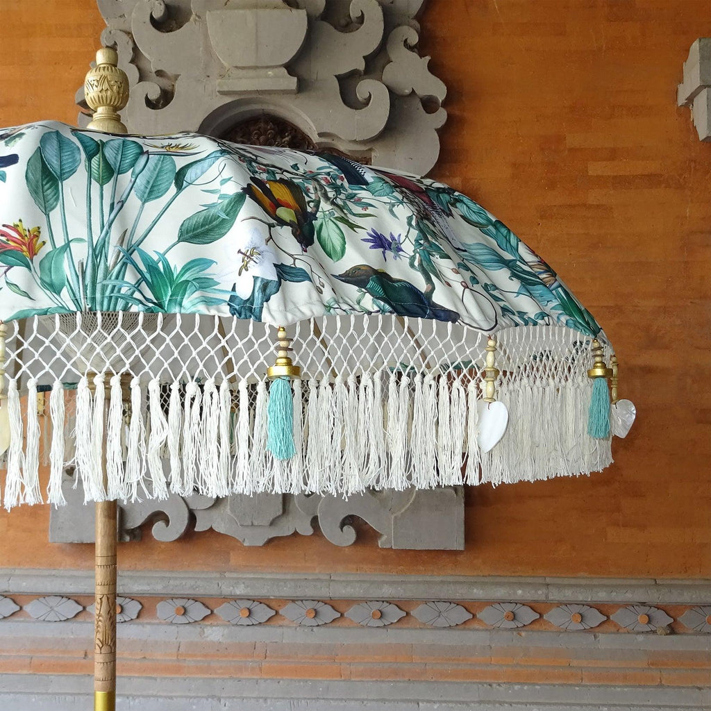 Detailed view of exotic birds and lush greenery on the Birdie Parasol, combining nature and elegance.