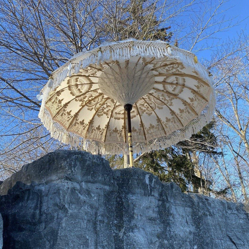 Golden Abbey Balinese Parasol with gold hand-painted design and white canvas, perfect for luxury outdoor spaces.