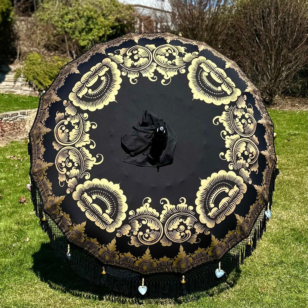 Close-up of Carl Parasol’s black fringe with brass accents and heart-shaped seashells.