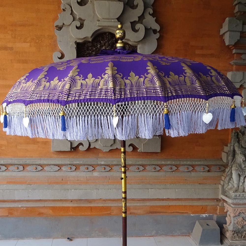 Artistic capture of Claudia Parasol’s gold and wooden beading with heart-shaped seashells.