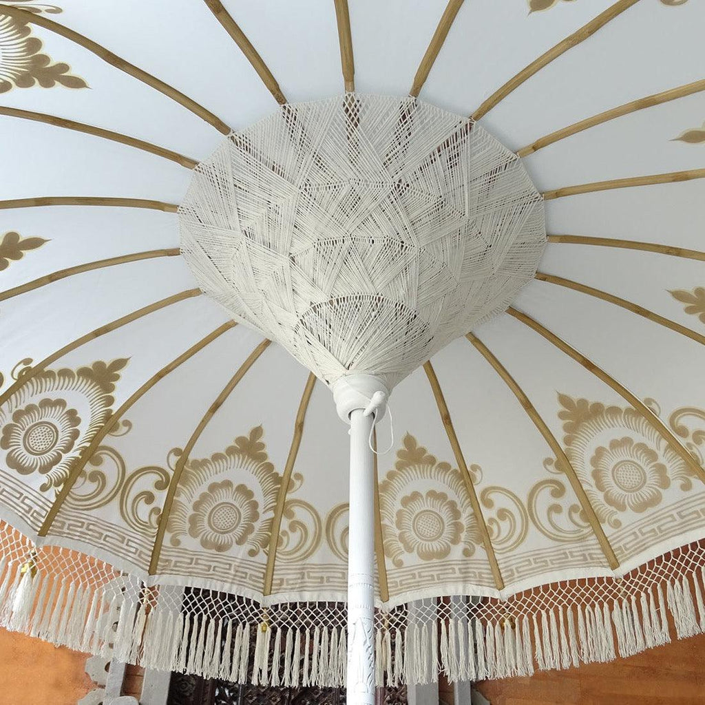 Elegant Ally Parasol with white canvas, gold accents, and a carved wooden pole—ideal for gardens and terraces.